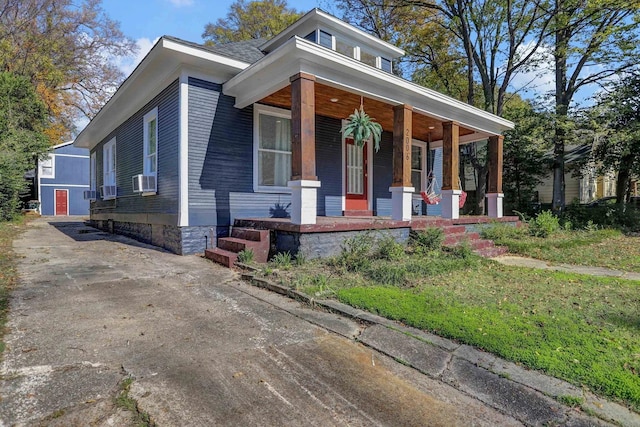 view of front facade featuring a porch and cooling unit