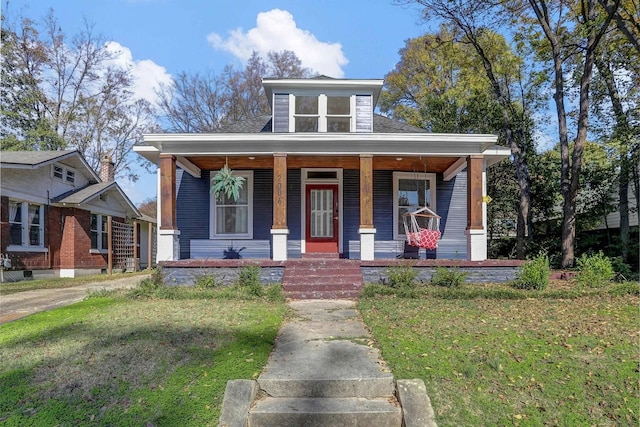 bungalow-style home with a porch and a front lawn