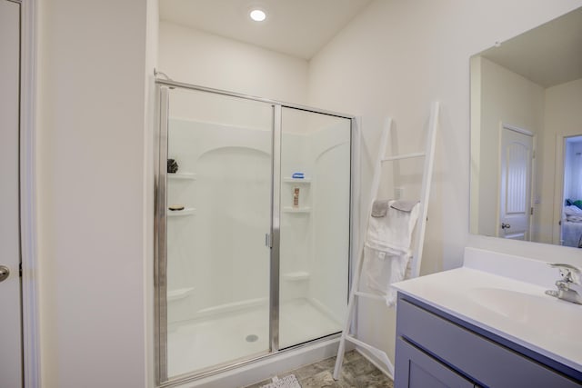 bathroom featuring a stall shower and vanity