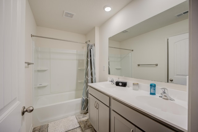 bathroom with double vanity, visible vents, shower / bath combo, and a sink