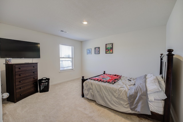 carpeted bedroom with visible vents and baseboards