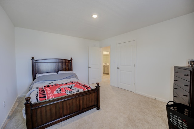 bedroom with light carpet and baseboards