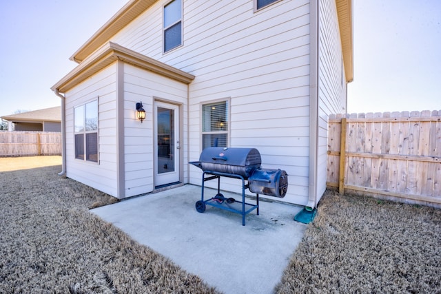 view of patio / terrace featuring a grill and fence