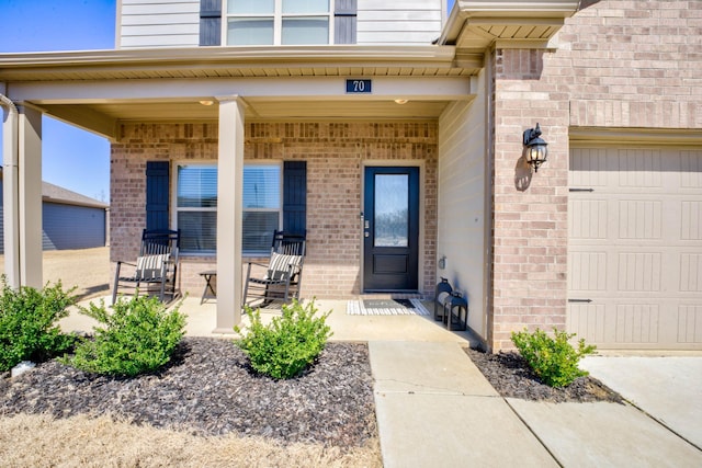 entrance to property with brick siding and covered porch