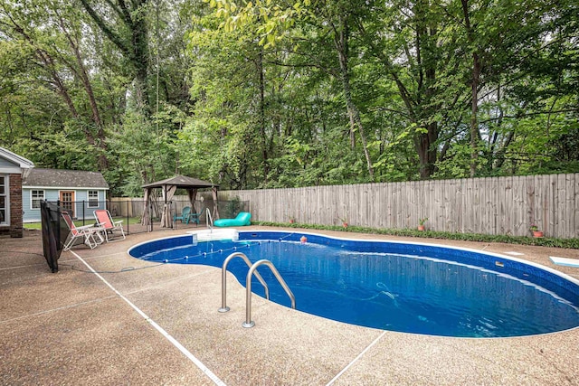 view of swimming pool with a gazebo, a fenced in pool, a fenced backyard, and a patio area