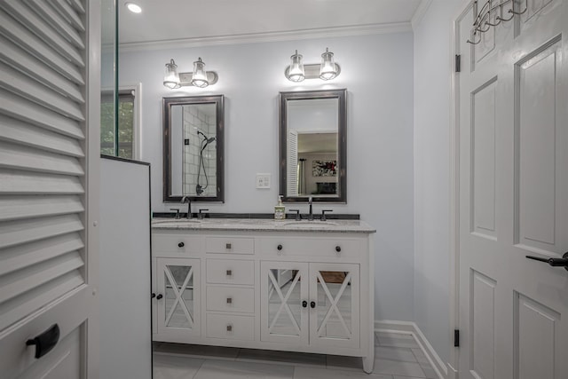 full bathroom featuring double vanity, crown molding, and a sink