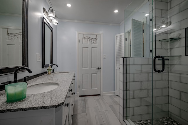 bathroom with ornamental molding, a stall shower, and a sink