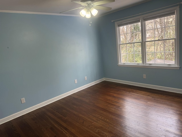 unfurnished room with dark wood finished floors, baseboards, a ceiling fan, and ornamental molding