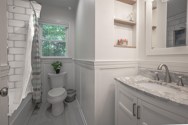 full bathroom with shower / bath combination with curtain, wainscoting, vanity, and toilet