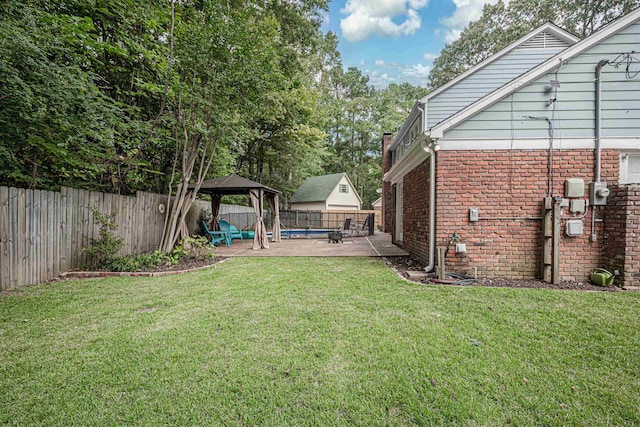 view of yard with a gazebo, a fenced backyard, and a patio area