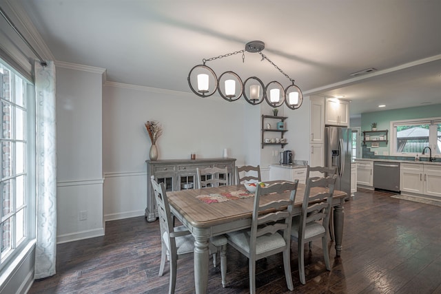 dining space featuring dark wood-style floors, visible vents, and ornamental molding