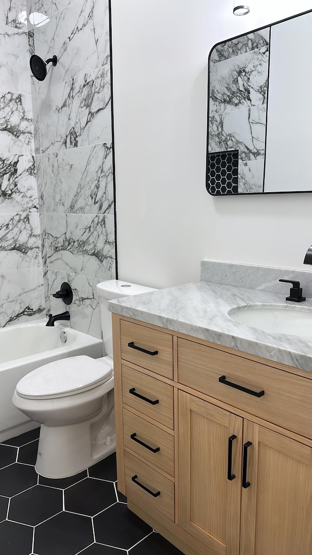 full bathroom with vanity, tile patterned floors, toilet, and tub / shower combination