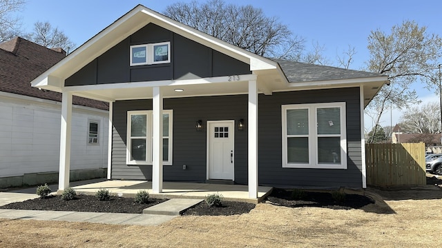 bungalow-style house with a porch and fence