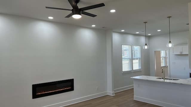 kitchen featuring a sink, recessed lighting, white cabinets, a ceiling fan, and dark wood-style flooring