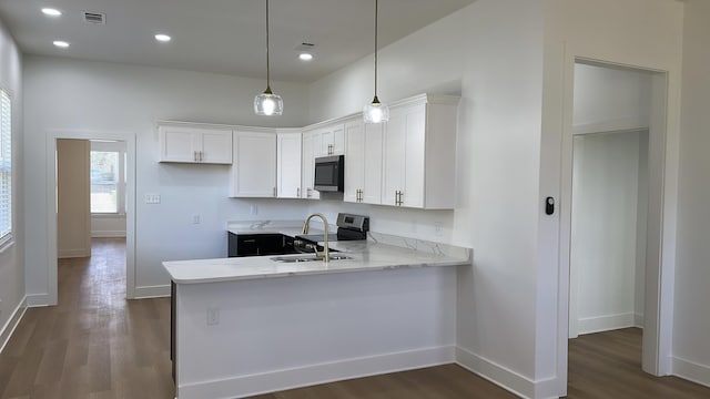 kitchen featuring a sink, dark wood finished floors, white cabinetry, and stainless steel appliances