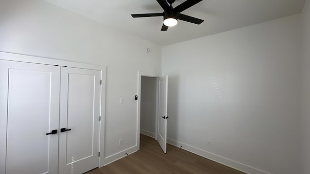 unfurnished bedroom with a ceiling fan, baseboards, and wood finished floors