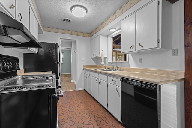 kitchen with black appliances, under cabinet range hood, a sink, white cabinets, and light countertops