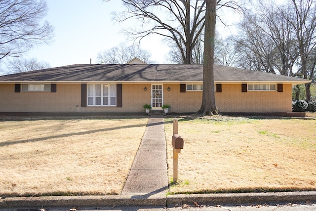 ranch-style home with a front lawn and brick siding