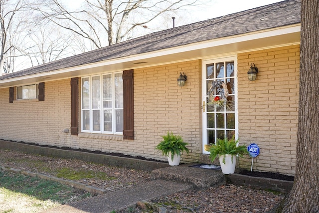 property entrance featuring brick siding