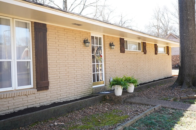 doorway to property with brick siding