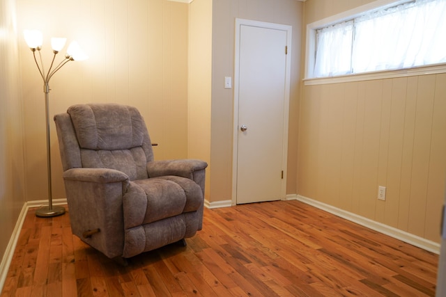 living area with baseboards and wood-type flooring