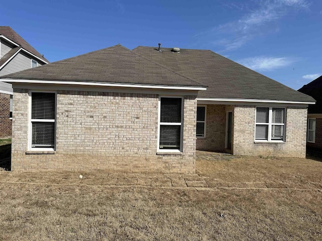 rear view of property with brick siding