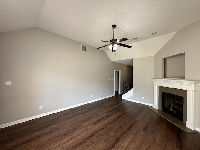 unfurnished living room with dark wood finished floors, visible vents, ceiling fan, and lofted ceiling