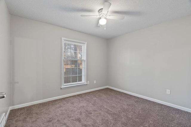 carpeted empty room with visible vents, a textured ceiling, baseboards, and a ceiling fan