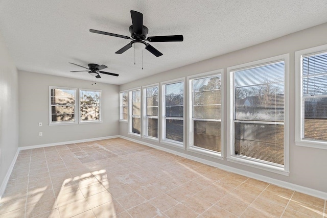 unfurnished sunroom with ceiling fan