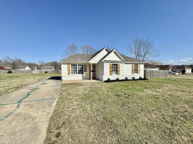 single story home with brick siding, driveway, a front lawn, and fence