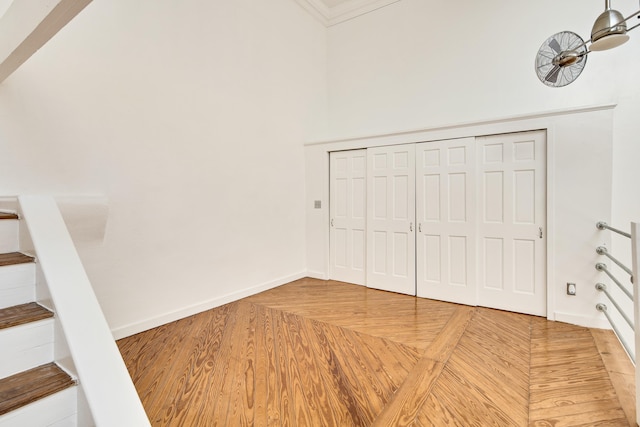 interior space featuring a closet, baseboards, and parquet floors