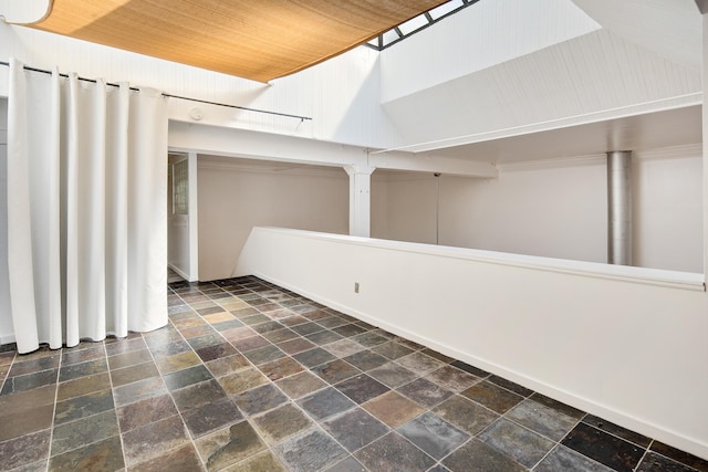 interior space featuring stone tile flooring and wooden ceiling