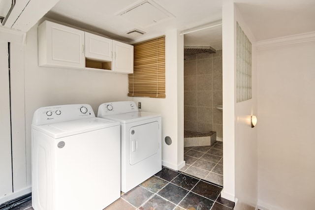 clothes washing area featuring ornamental molding and washing machine and clothes dryer