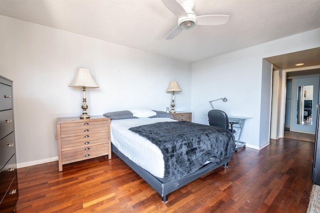 bedroom with a textured ceiling, a ceiling fan, baseboards, and wood finished floors