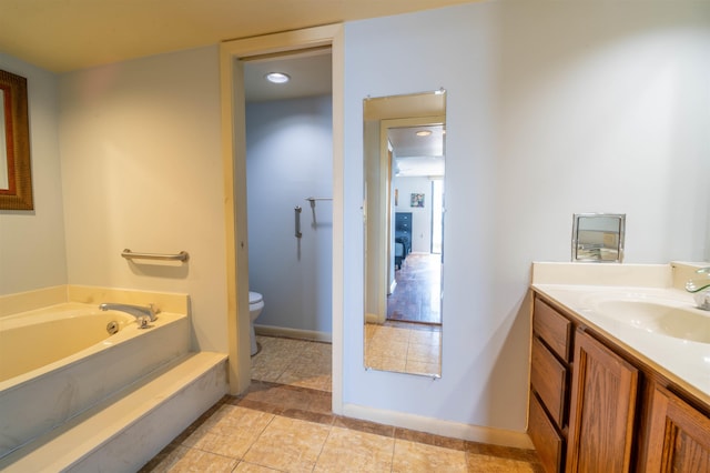 full bath featuring baseboards, toilet, vanity, and a garden tub