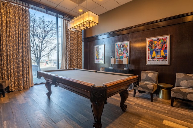 game room with a paneled ceiling, a notable chandelier, wood finished floors, and billiards