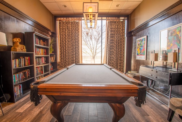 rec room featuring a wealth of natural light, a paneled ceiling, and wood finished floors