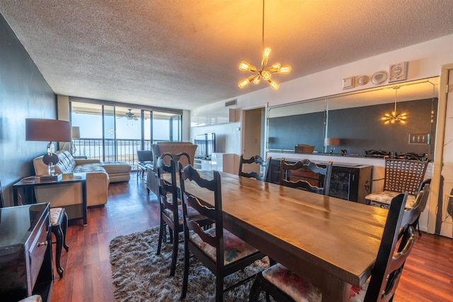 dining room with a wall of windows, an inviting chandelier, wood finished floors, and a textured ceiling