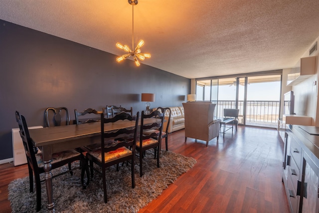 dining room with expansive windows, visible vents, dark wood finished floors, a textured ceiling, and a chandelier