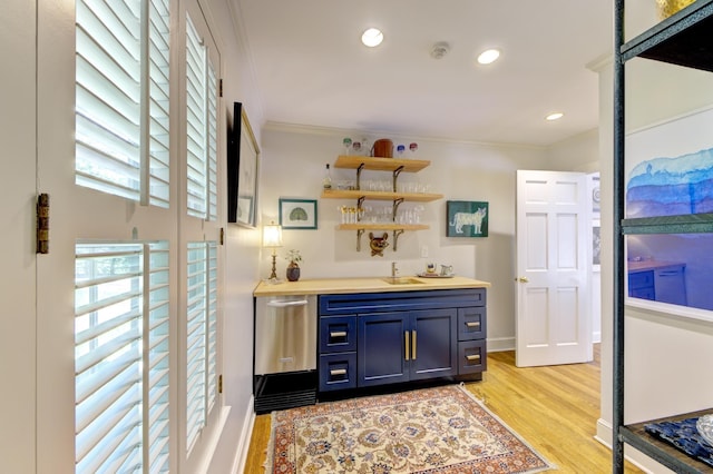 bar featuring wet bar, recessed lighting, a sink, ornamental molding, and light wood-type flooring