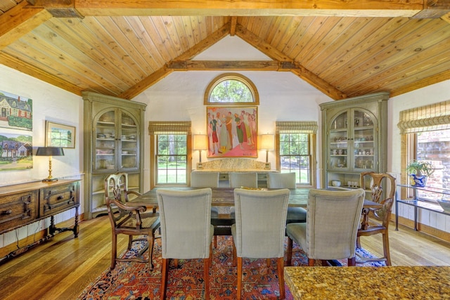 dining space featuring wooden ceiling, light wood-style flooring, and vaulted ceiling with beams