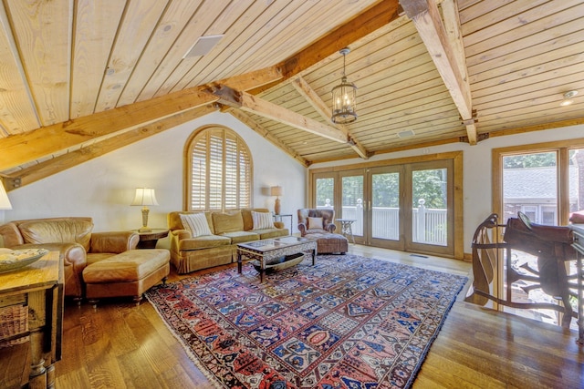 living area with lofted ceiling with beams, wood finished floors, a wealth of natural light, and wooden ceiling