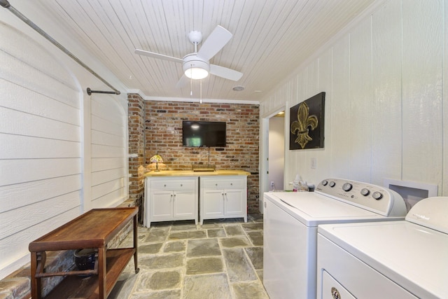 laundry area featuring ornamental molding, stone finish floor, separate washer and dryer, wooden ceiling, and ceiling fan