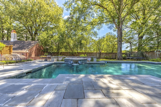 view of swimming pool with a patio, a fenced in pool, a fenced backyard, a hot tub, and a trampoline