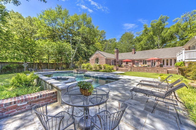 view of patio / terrace featuring a fenced in pool, outdoor dining area, and fence