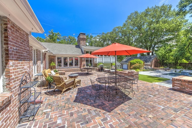 view of patio featuring fence and french doors