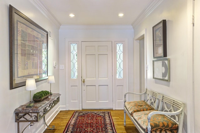 entrance foyer featuring recessed lighting, wood finished floors, and ornamental molding