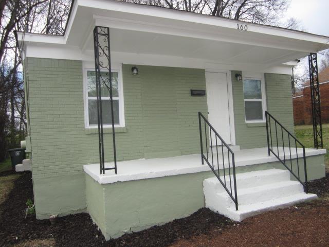 view of exterior entry featuring brick siding