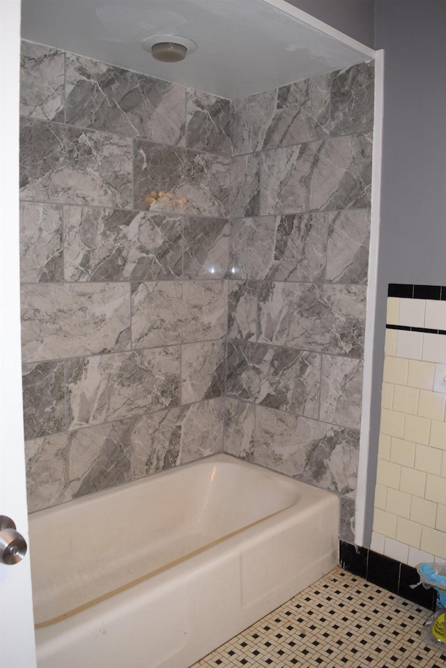 bathroom with tile patterned flooring and shower / bath combination