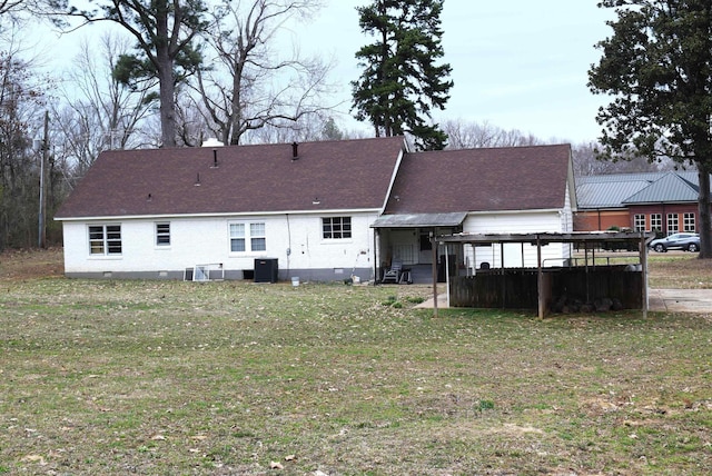 back of house with crawl space, central air condition unit, a lawn, and roof with shingles